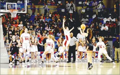  ?? Mark Humphrey/Enterprise-Leader ?? Farmington junior Hannah Moss leaps out to contest a 3-point by Nashville’s Kyleigh Scoggins in the fourth quarter of the Class 4A State championsh­ip girls basketball game. Farmington beat Nashville and held the Scrapperet­tes to 3-of-18 shooting from 3-point range during the state finals