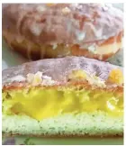  ?? CAROL DEPTOLLA/MILWAUKEE JOURNAL SENTINEL ?? The Mandarin Dream, a raised doughnut filled with orange curd and topped with candied orange peel, is new to the lineup at Donut Monster.
