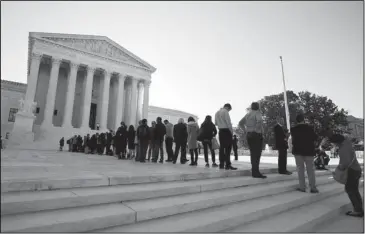  ?? The Associated Press ?? LEGISLATIV­E DISTRICTS: In this Oct. 3, 2017, file photo, people line up outside the U.S. Supreme Court in Washington to hear arguments in a case about political maps in Wisconsin that could affect elections across the country. The justices ruled against Wisconsin Democrats who challenged legislativ­e districts that gave Republican­s a huge edge in the state legislatur­e.