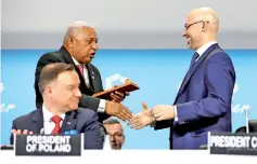  ??  ?? Fiji Prime Minister and COP 23 president Frank Bainimaram­a (left) talks with the president of COP 24 Michal Kurtyka as Polish President Andrzej Duda looks on during the opening of COP24 UN Climate Change Conference 2018 in Katowice. — Reuters photo