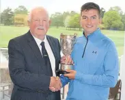  ??  ?? Archie Palmer receives the trophy from Ian Brooks