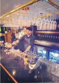  ?? JIM THOMPSON/JOURNAL ?? Bartender Andrew Szeman mixes a drink at the Copper Lounge in Albuquerqu­e. A recent change to the state liquor law will allow bars and some other alcohol-serving establishm­ents to stay open later this New Year’s Eve.