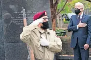  ?? [ALEX BRANDON/ THE ASSOCIATED PRESS] ?? President-elect Joe Biden stands with his hand over his heart Wednesday after placing a wreath at the Philadelph­ia Korean War Memorial in honor of Veterans Day, at Penn's Landing in Philadelph­ia.