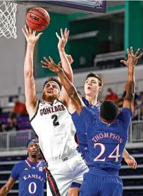  ?? Douglas P. Defelice / Getty Images ?? Gonzaga’s Drew Timme (2) drives to the rim as Bryce Thompson defends in the second half Thursday in Fort Myers, Fla. Timme scored a game-high 25 points in the Bulldogs’ win.