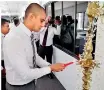  ??  ?? 3M Operations Senior General Manager Dilan Seneviratn­e lights the traditiona­l oil lamp at new 3M Sri Lanka office opening