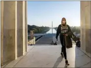  ?? J. SCOTT APPLEWHITE - THE AP ?? In this Nov. 8 photo, a woman wears a Biden-Harris campaign shirt as she and others gather at the Lincoln Memorial at sunrise, Sunday, Nov. 8, the morning after incumbent President Donald Trump was defeated by his Democratic challenger President-elect Joe Biden.