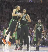  ?? Mitchell Leff / Getty Images ?? Jayson Tatum, left, and Al Horford celebrate the Celtics’ Game 3 win over the 76ers on Saturday.