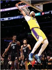  ?? KATELYN MULCAHY — GETTY IMAGES ?? Anthony Davis of the Lakers dunks as the Pistons’ Jalen Duren, left, and Cade Cunningham look on during the first quarter of Tuesday night’s game at Crypto.com Arena.
Online: