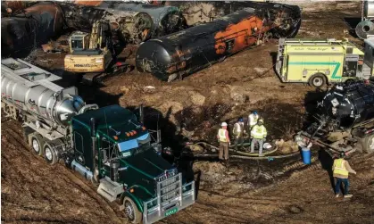  ?? Photograph: Tannen Maury/EPA ?? Workers remove contaminan­ts as cleanup continues at the site of the derailment in East Palestine, Ohio.