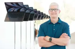  ?? JUSTIN SULLIVAN/GETTY ?? Apple CEO Tim Cook stands next to a display of newly redesigned MacBook Air laptops Tuesday during a developer’s conference in Cupertino, California.