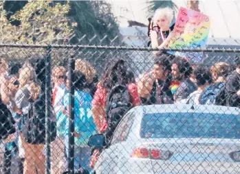  ?? JOE BURBANK/ORLANDO SENTINEL ?? Students wave flags and signs March 4 to protest Florida’s “Don’t Say Gay” bill.