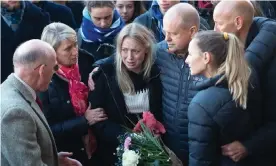  ?? Photograph: Joe Giddens/PA ?? Leanne O’Brien, centre, the girlfriend of Jack Merritt, is comforted by family members during a vigil at the Guildhall, in Cambridge.