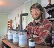  ?? JOURNAL SENTINEL ANGELA PETERSON/MILWAUKEE ?? After doing business at farmers markets for the last few years, Kyle Denton recently opened Tippecanoe Herbs in Walker's Point.