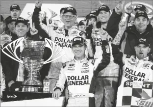  ?? TERRY RENNA/AP ?? MATT KENSETH (CENTER) stands next to the trophy in Victory Lane after winning the Sprint Unlimited auto race at Daytona Internatio­nal Speedway, on Feb. 14, 2015, in Daytona Beach, Fla.