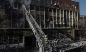  ?? Photograph: Michele Spatari/AFP/Getty Images ?? The fire-damaged multi-storey building in central Johannesbu­rg. It was said to house about 400 people.