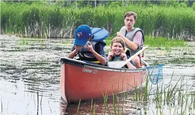  ?? JIM RANKIN PHOTOS/TORONTO STAR ?? Campers hunt for turtles and leeches in the swamp near Camp Kirk, which is located on the outskirts of Kirkfield, Ont.