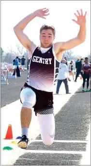  ?? Westside Eagle Observer/RANDY MOLL ?? Brandon Atwood of Gentry clears some ground in the triple jump at the Gravette High School Relays track meet on March 15.