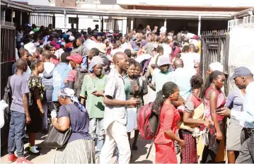  ??  ?? People gather at the Registrar-General’s Office near Market Square in Harare to apply for and collect identity documents yesterday. Picture: Justin Mutenda