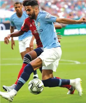  ??  ?? Manchester City’s Riyad Mahrez, right, goes for the ball during the first half of an Internatio­nal Champions Cup tournament soccer match against FC Bayern Photo: AP