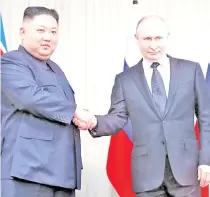  ?? — Reuters photo ?? Putin (right) and Kim shakes hands during their talks at Far East Federal University on Russky Island in Vladivosto­k.