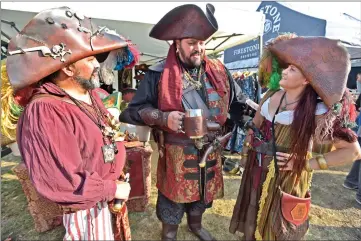  ?? Dan Watson/The Signal ?? Attendees dressed in pirate costumes, from left, Javier Dominguez, Edgar Barragan and Janice Dominguez chat at the fourth annual SCV Brewmaster­s Pirate Beer Festival held at Vista Valencia Golf Course on Saturday.