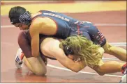  ?? Scott Herpst ?? Heritage’s Brayden Slaughter locks up with Clay Hathaway of Chattanoog­a Valley during a meet in Flintstone this past Wednesday.