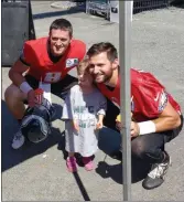  ?? MEDIANEWS GROUP ?? Quarterbac­ks Clayton Thorson and Cody Kessler pose with an Eagles’ fan at the Rita’s Water Ice tent after the Monday morning practice at the NovaCare Complex.