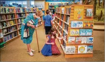  ?? CHANG W. LEE / NYT ?? Customers wearing face masks browse the children’s books section of a Barnes & Noble store. Retail locations shuttered during lockdowns, so the company spruced up its stores.