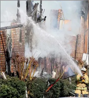  ?? Arkansas Democrat-Gazette/STEPHEN B. THORNTON ?? Pine Bluff firefighte­rs battle a fire Wednesday at the Country Club Plaza apartments, which sustained heavy damage and displaced the residents of all 30 units at the complex at 4201 S. Cherry St. All the tenants got out and no one was injured, Fire...