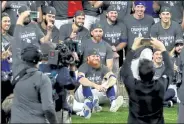  ?? RONALD MARTINEZ / Getty Images ?? Dodgers’ Justin Turner, center, sits with his team for a photo after defeating the Rays 3-1 in Game 6 to win the 2020 MLB World Series at Globe Life Field Tuesday in Arlington, Texas.