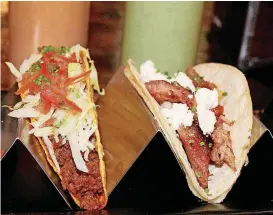  ?? [PHOTO BY DAVE CATHEY, THE OKLAHOMAN] ?? A house taco and a Taco al Pastor from Hacienda Tacos, which opened Friday in the Shoppes at Northpark.