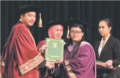  ??  ?? Abdul Aziz (left) handing over a certificat­e to a graduate. – Photos by Jeffery Mostapa