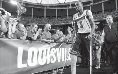  ?? AP/JOHN BAZEMORE ?? Fans cheer as Louisville guard Kevin Ware takes the court before Louisville’s victory over Wichita State on Saturday at the Georgia Dome in Atlanta. Ware was injured in Louisville’s regional semifinal victory over Duke, but was able to join his...