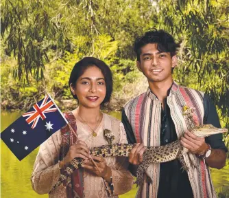  ??  ?? Ifrah and her brother Afan Mahmood, with Dudley the crocodile, became Australian citizens at a ceremony at Billabong Sanctuary yesterday. Picture: Evan Morgan