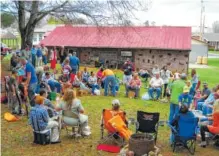  ?? PHOTO BY JOHNSON CITY PRESS ?? In the Peters Hollow Egg Fight, competitor­s form a circle with their lawn chairs and tap the ends of their neighbor’s eggs until the weaker egg cracks. Once all the eggs of a contestant are cracked on both ends, the contestant withdraws and the circle...