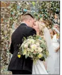  ?? PHOTOS BY CARY JENKINS ?? The newlyweds kiss after being introduced at the reception.