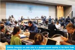 ?? — AFP ?? GENEVA: Delegates are seen prior to a general council meeting of the World Trade Organizati­on (WTO) yesterday at the trade intergover­nmental organizati­on headquarte­rs in Geneva.