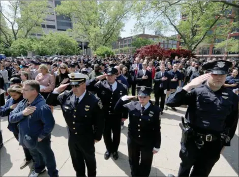  ?? JONATHAN TRESSLER — THE NEWS-HERALD ?? Public safety personnel and the public participat­e in honoring America as its anthem is performed May 19 during the 32nd annual Greater Cleveland Peace Officers Memorial Parade and Memorial Service in downtown Cleveland.