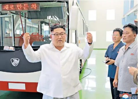  ??  ?? Kim Jong-un, the North Korean leader gesticulat­es on a visit to see a new type of trolley bus. The US state department yesterday said Mr Trump had written a letter to the dictator