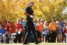  ??  ?? Phil Mickelson watches his tee shot on the first hole during the final round. He shot 75 to fall into a tie for 36th at 7-under.