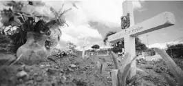  ?? CARLOS GIUSTI/AP ?? A burial site at the municipal cemetery in Vieques, Puerto Rico, on Sept. 8.