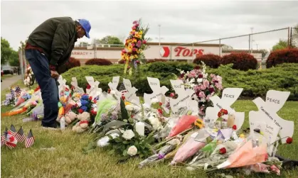  ?? ?? A man mourns at a memorial at the scene of a shooting at a Tops supermarke­t in Buffalo, New York, in May. Photograph: Lindsay Dedario/ Reuters