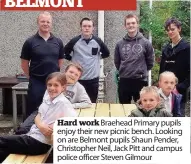  ??  ?? Hard work Braehead Primary pupils enjoy their new picnic bench. Looking on are Belmont pupils Shaun Pender, Christophe­r Neil, Jack Pitt and campus police officer Steven Gilmour