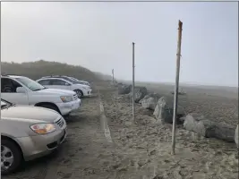  ?? ?? Vehicles line the parking lot at Fairhaven beach in Samoa after residents were warned to stay away from the water.