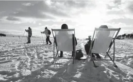  ?? JUSSI NUKARI/LEHTIKUVA ?? People sit in the sun last month in Helsinki, Finland. For the fourth consecutiv­e year, Finland topped the list of all countries in the World Happiness Report.