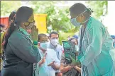  ?? ?? MP Meenakshi Lekhi distribute­s protein packets to medical staff at Sir Ganga Ram Hospital in New Delhi.