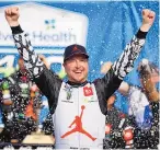  ?? COLIN E. BRALEY/ASSOCIATED PRESS ?? Kurt Busch celebrates his victory on Sunday at Kansas Speedway, giving a racing team founded by Michael Jordan and Denny Hamlin its second NASCAR win.