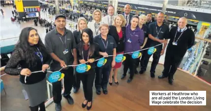  ??  ?? Workers at Heathrow who are all paid the London Living Wage celebrate the decision