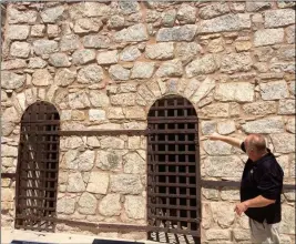  ?? PHOTOS BY MARA KNAUB/YUMA SUN ?? PARK MANAGER MIKE GUERTIN SHOWS THE TWO-AND-A-HALF CELLS built by the first inmates at the Yuma Territoria­l Prison. The first prisoners arrived on July 1, 1876, and immediatel­y began to build their own cells.