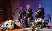  ?? ?? (From left) Bandmates Jeff Sandow, Kenny Aronhalt and Pastor Jim Britton perform at the celebratio­n of Doug Gibson’s life.